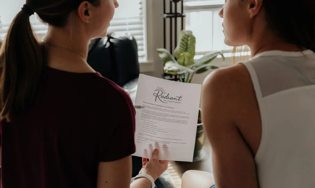 Dr. Danaya and a patient reviewing the Radiant Pelvic Health intake form together during a first visit